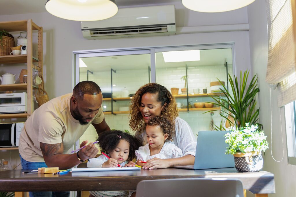 African father and mother painting with child