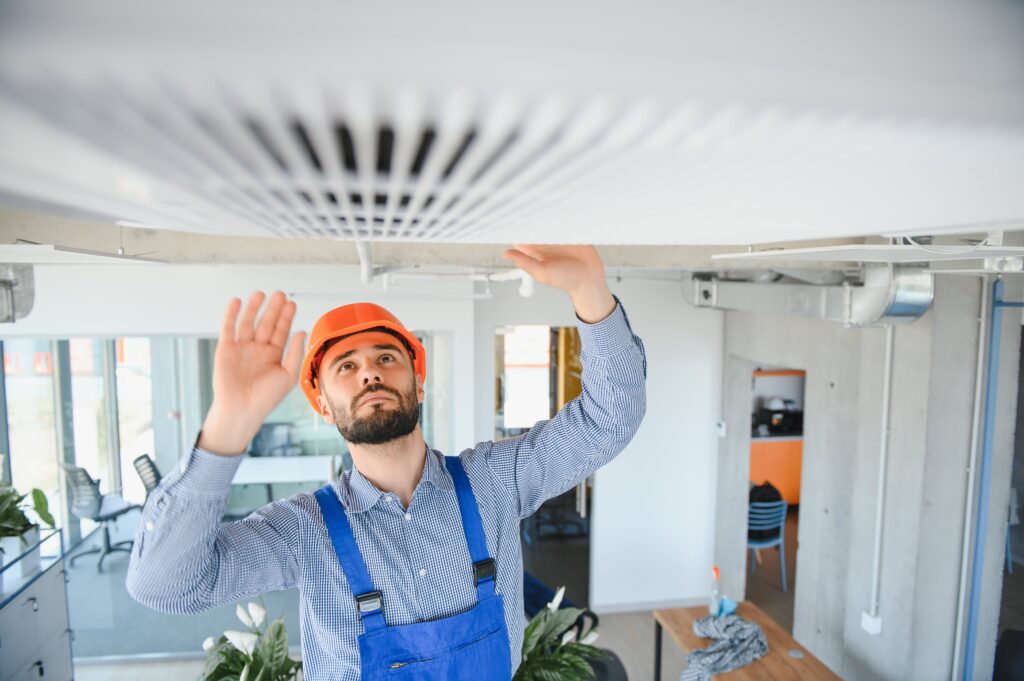 Technician service checking and repairing air conditioner indoors